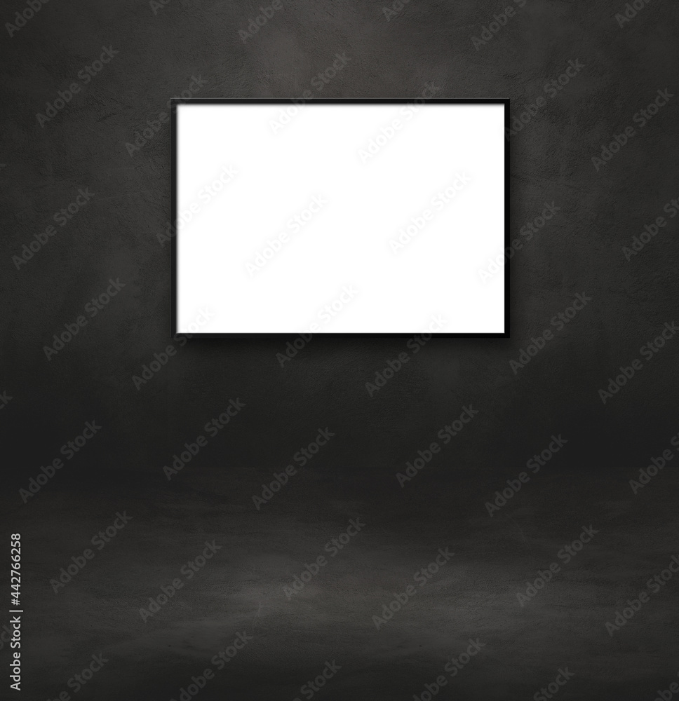 Blank picture frame hanging on a black wall Blank picture frame hanging on a black wall