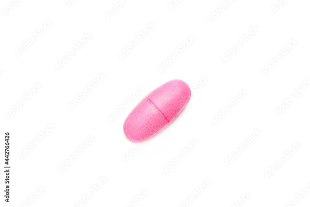 One single pink pill on white background, multivitamin tablet or dietary supplement One single pink pill on white background, multivitamin tablet or dietary supplement