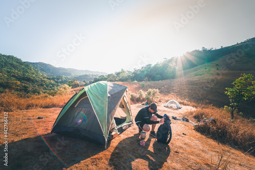 Bild auf Leinwand wanderlust and relax in nature with hiker man camping on top of mountain on spri