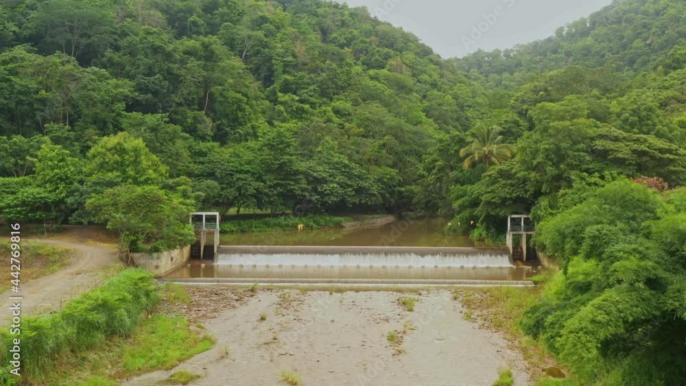 An aerial view of the weir running through the water. water flowing from the forest Northern Thailand An aerial view of the weir running through the water. water flowing from the forest Northern Thailand