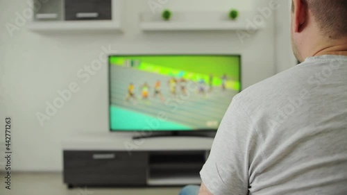 Man's lower back was pinched or ached after he got up from the sofa. Pain in muscle of lumbar region or lower back spine, radiculitis concept. Guy suffers from lumbago in nerves and bones