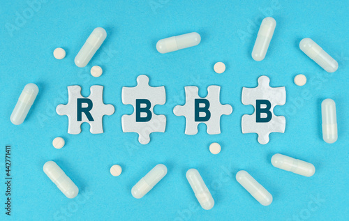 On a blue background, there are pills and puzzles with the inscription - RBBB