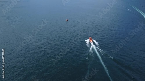 Motorboat moves in Como lake, aerial view from the drone