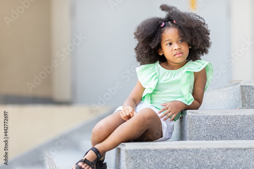 Childhood concept and lifestyle learning Sitting on the stairs in front of the school building.