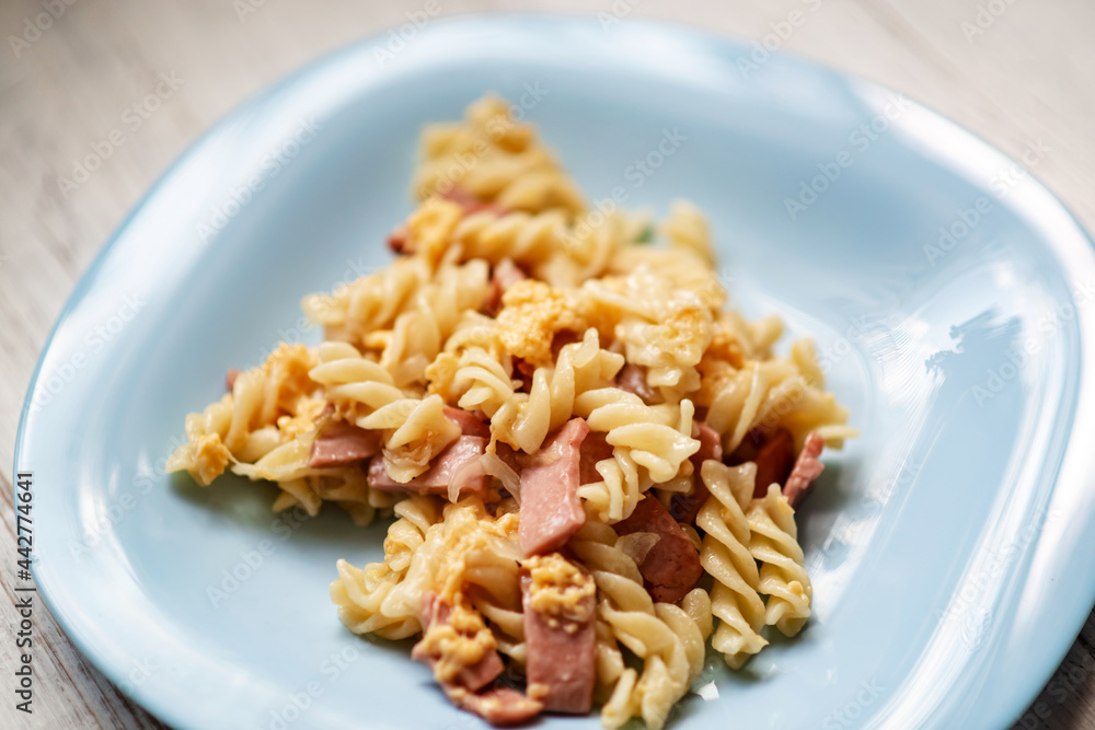 Pasta with bacon and cheese with a creamy sauce.