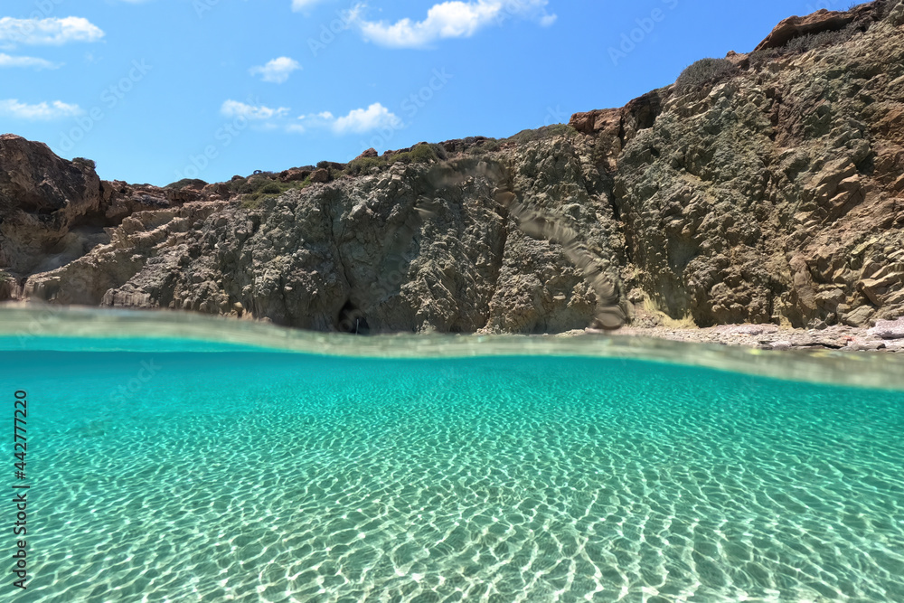 Underwater split photo of beautiful beach of Kalogria with emerald crystal clear sea, Milos island, Cyclades, Greece