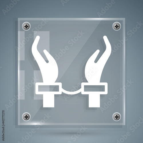 White Handcuffs on hands of criminal man icon isolated on grey background. Arrested man in handcuffs. A crime, arrest, business and corruption concept. Square glass panels. Vector