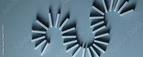 Fotografie Light Blue wood domino pieces on light blue background