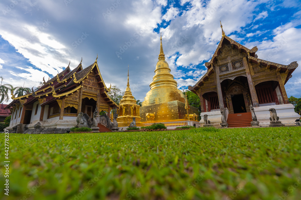 Fototapeta premium Tourist visiting Wat Phra Singh temple one of the best examples of classic Lanna style architecture in Chiang Mai province of Thailand.