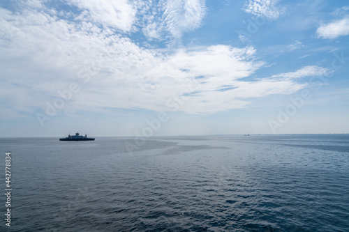 view of the Langeland Ferry crossing the open ocean from Langeland Island to Lolland Island in Denmark © makasana photo