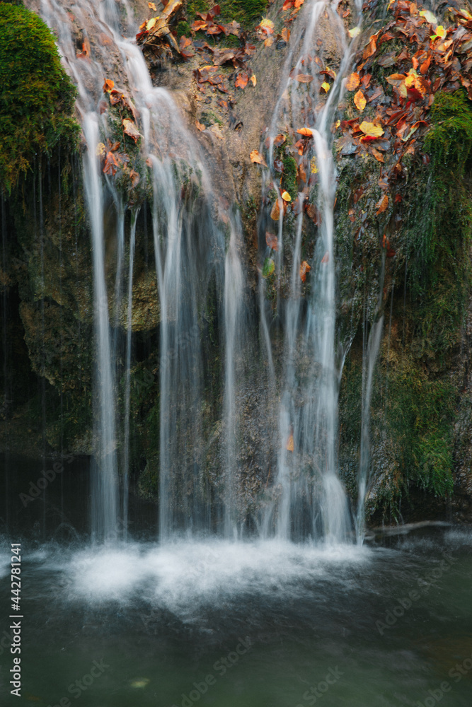 Naklejka premium Thin streams of a mountain waterfall