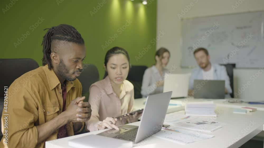 Corporate employees actively discussing projects, working in business office Corporate employees actively discussing projects, working in business office