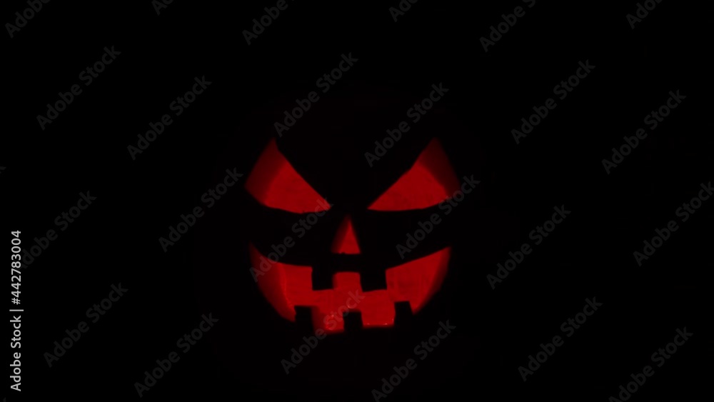 Scary laughing pumpkin on a dark background. Halloween, witchcraft and magic. Scary laughing pumpkin on a dark background. Halloween, witchcraft and magic.
