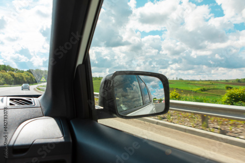 car travel concept road reflection in rear mirror view