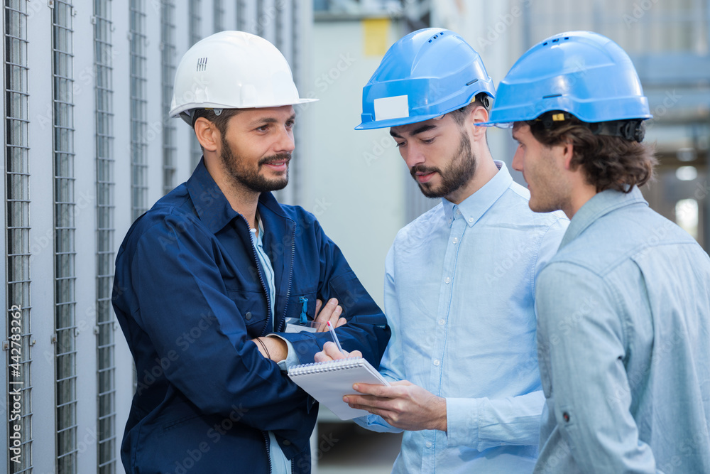 engineers during conversation outside factory engineers during conversation outside factory