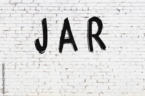 White wall with black paint inscription jar on it