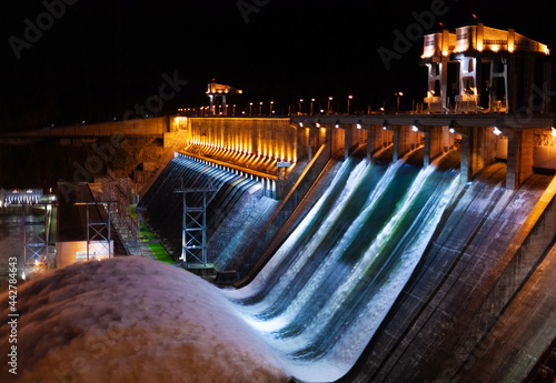 Spillway water to hydroelectric power station in Krasnoyarsk, Russia. Night industrial landscape with open locks on Krasnoyarsk Dam