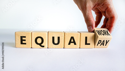 Equal pay and work symbol. Businessman turns wooden cubes and changes words equal pay to equal work. Beautiful white background. Copy space. Business and equal pay and work concept. photo
