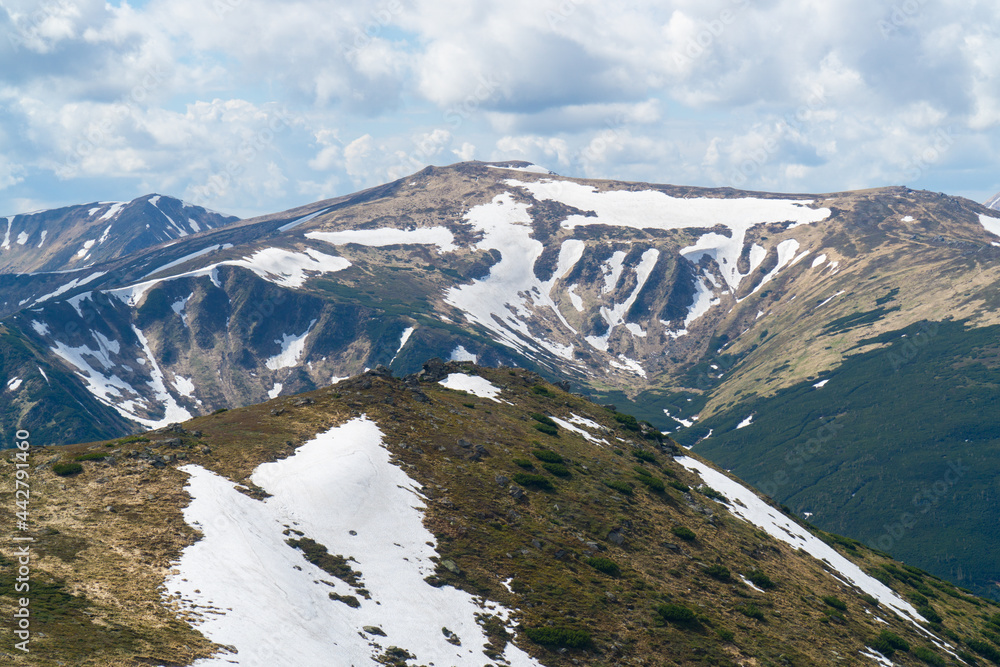 summer mountains in snow on a cloudy day