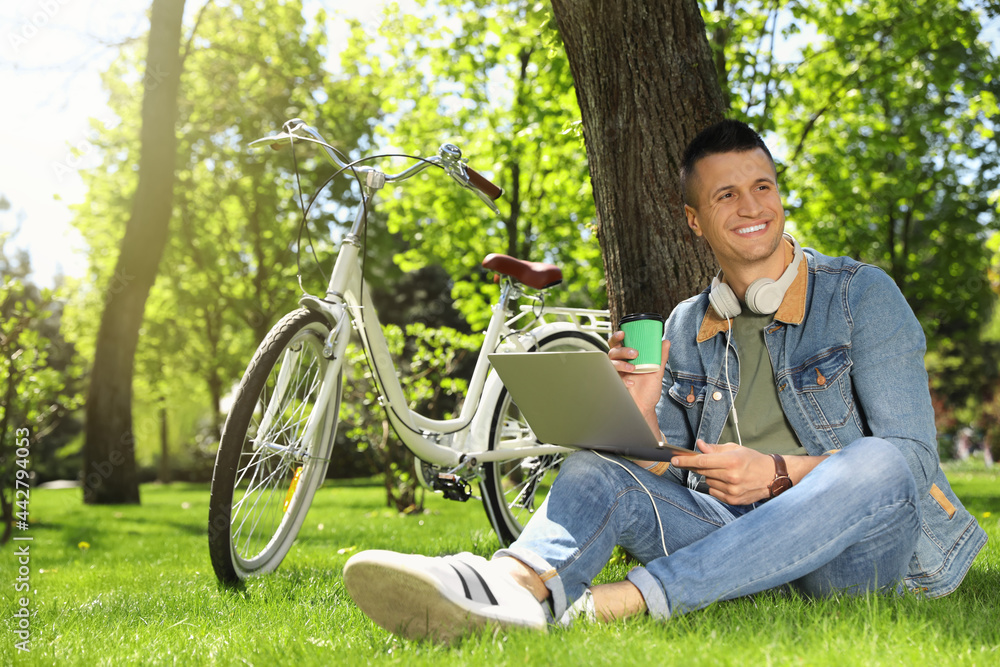 Man taking coffee break during work in park Man taking coffee break during work in park