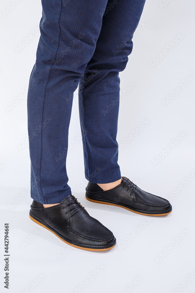 A man is wearing classic black shoes made of natural leather on lace, shoes for men under business style A man is wearing classic black shoes made of natural leather on lace, shoes for men under business style