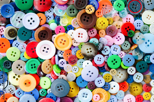 Colorful mixed sewing buttons background. Top view