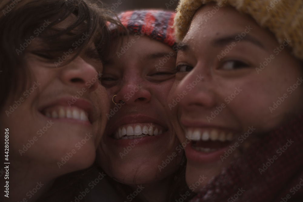 three cute happy women laugh and smile for selfie in winter in europe three cute happy women laugh and smile for selfie in winter in europe