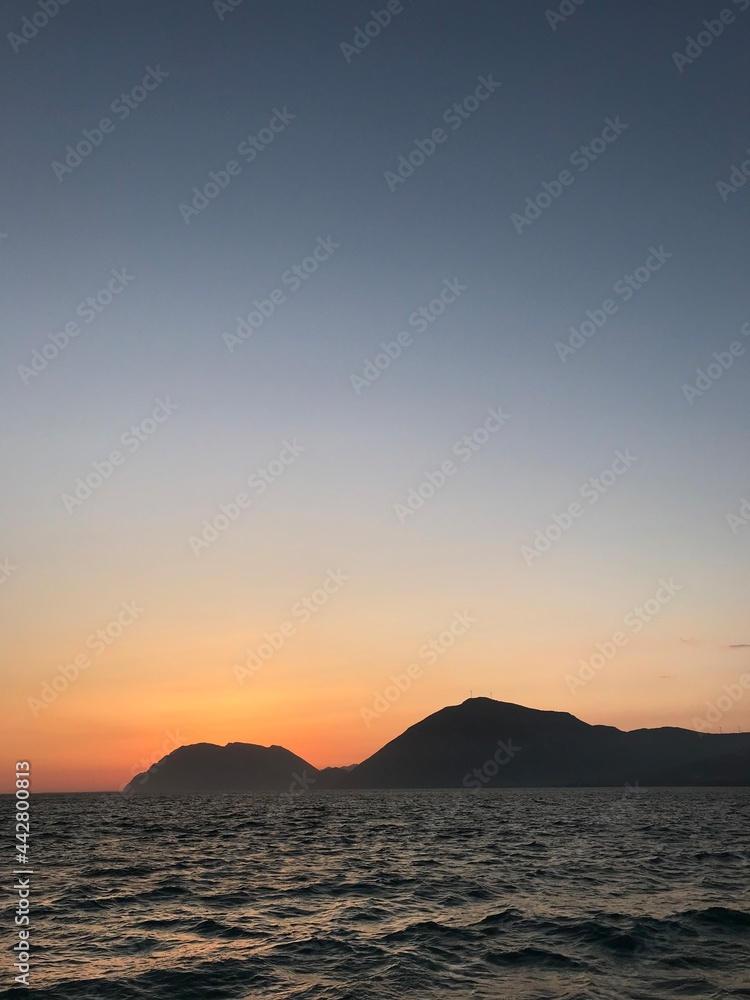 Sunset over the sea and mountains in Greece, Rio.
