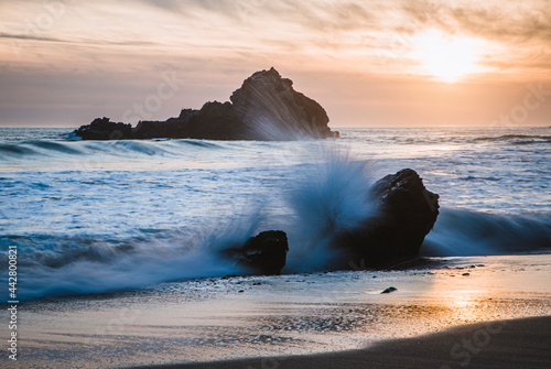 Wave breaks over rock at sunset, Pfeiffer Beach, Big Sur California