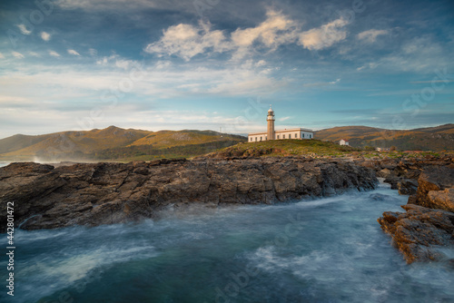 Beautiful lighthouse in Galicia on the cliffs during a spring day photo