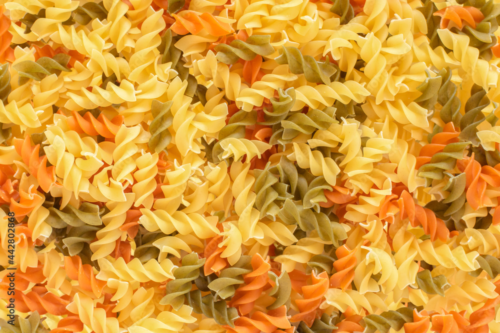 background of colored pasta scattered on the table background of colored pasta scattered on the table