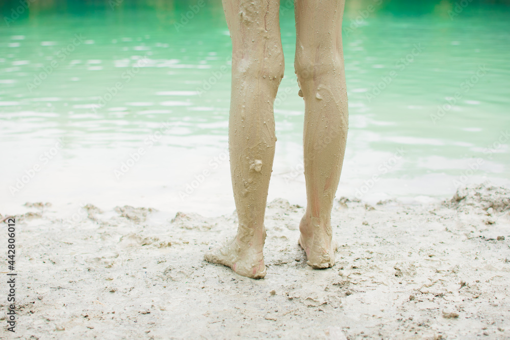 Woman legs in kaolin clay. Wellness, spa, healthy skin and relax concept. Woman legs in kaolin clay. Wellness, spa, healthy skin and relax concept.