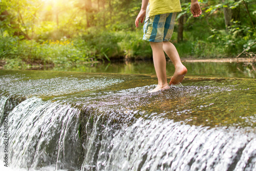 Wallpaper Mural Kids legs walkingin watere  in stream in the summer. Outdoor, barefoot, holiday concept Torontodigital.ca