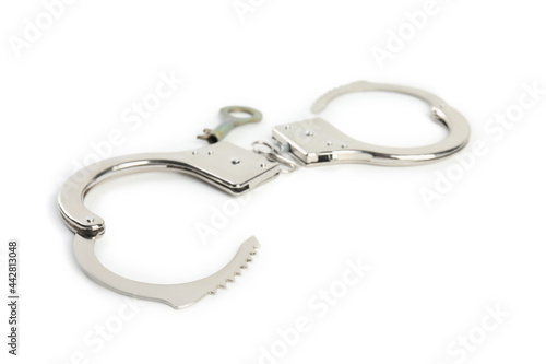 Classic chain handcuffs with key on white background