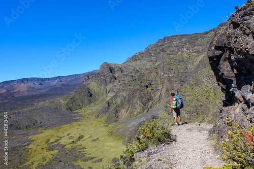 Man / boy Hiking and camping in the crater / Dormant volcano, Halemau'u Trail. Haleakala National Park, Maui island, Hawaii