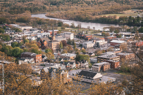 Photography A city with a river running through it, - view of Port Jervis, New York from Elk