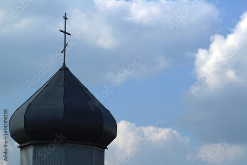 Dome of orthodox church and cross and the clouds on the blue sky. Christianity religion background