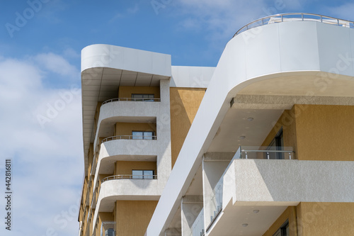bottom view of modern building with balconies and terraces to accommodate tourists on vacation