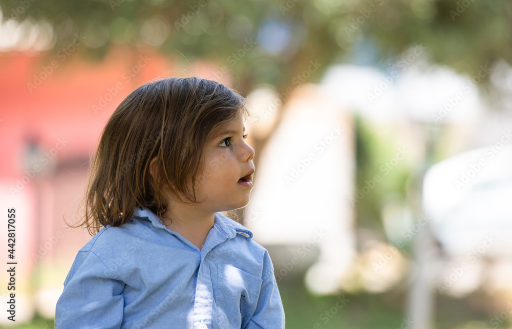 A little boy, about 2.5 years old, is looking aside and staring at something and he looks amazed from what he is seeing. A little boy, about 2.5 years old, is looking aside and staring at something and he looks amazed from what he is seeing.
