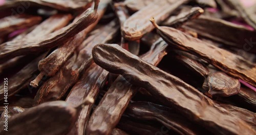 Carob dried fruit close-up. Advertising of food does not contain caffeine, wholesome food and drinks from the carob