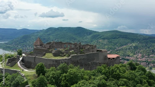 Visegrad, Hungary - Aerial panoramic view of the remains of the beautiful High Castle or Upper Castle of Visegrad with the Danube bend and the city of Nagymaros in the background. photo