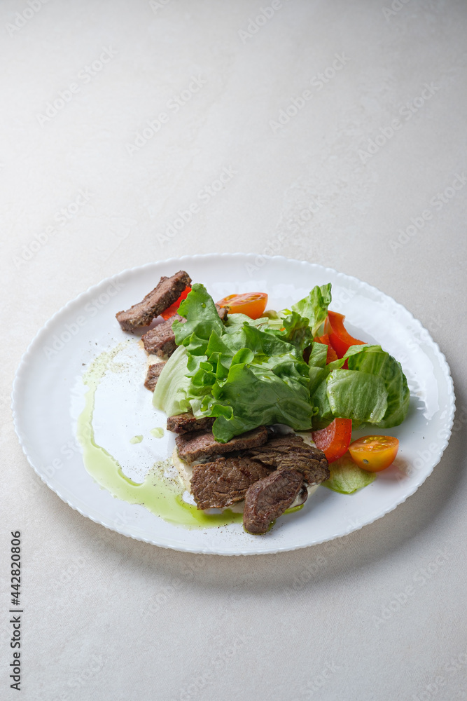 Menu for the restaurant: salad with beef, lettuce and cherry tomatoes with olive oil, lime and spice dressing. Menu for the restaurant: salad with beef, lettuce and cherry tomatoes with olive oil, lime and spice dressing.