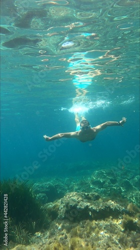 young man snorkeling in Menorca 
