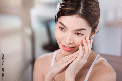 Asian woman with beautiful skin face non makeup, pure cosmetic at the white office.