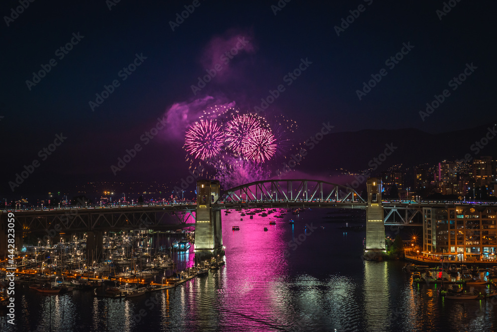Vancouver Celebration of Light fireworks festival in English bay with Burrard bridge over False Creek