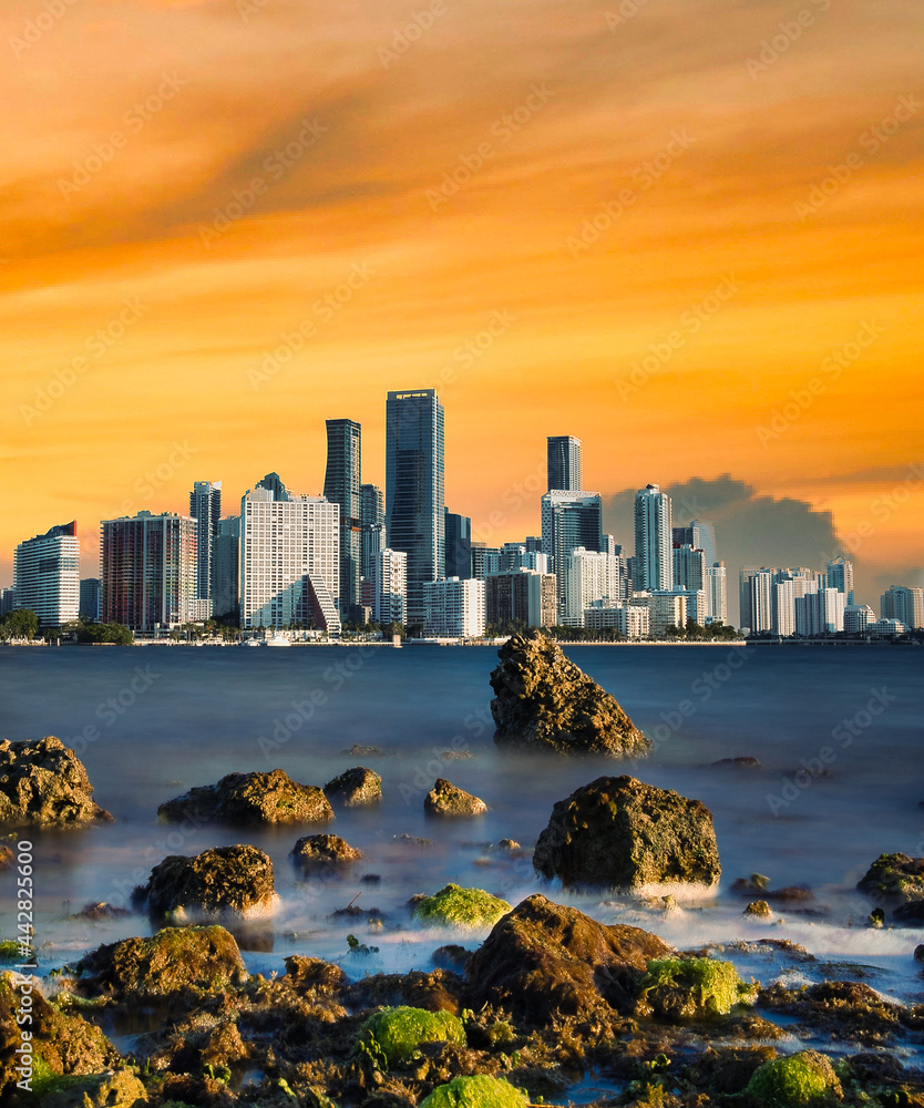 Fototapeta premium Miami Florida city skyline at sunset miami beautiful sea panorama ocean buildings Brickell downtown sky orange rocks water 