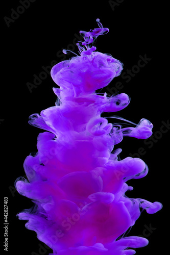 Purple-pink paint in water isolated on black background