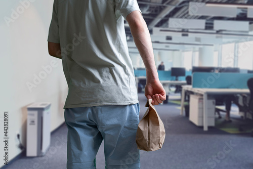 person holding fast food paper bag, takeaway food and drink delivery