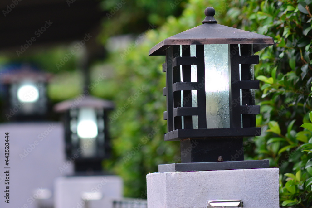 Vintage lamps adorned on the fence in front of the house