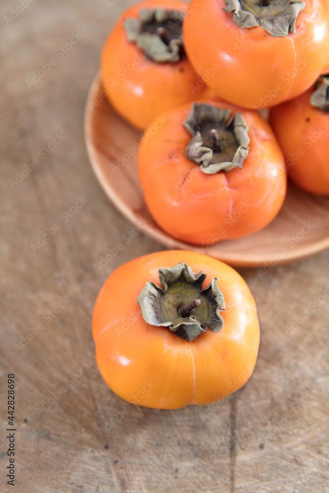 Ripe ruddy crisp persimmons in autumn Ripe ruddy crisp persimmons in autumn